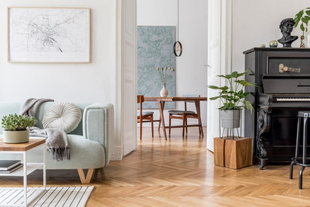 Pristine modern living room with light blue sofa and polished herringbone wood floors by MM Maid Cleaning.